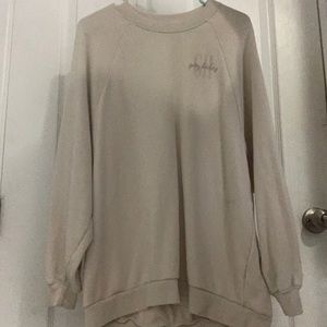A tan/beige long sleeve sweater.